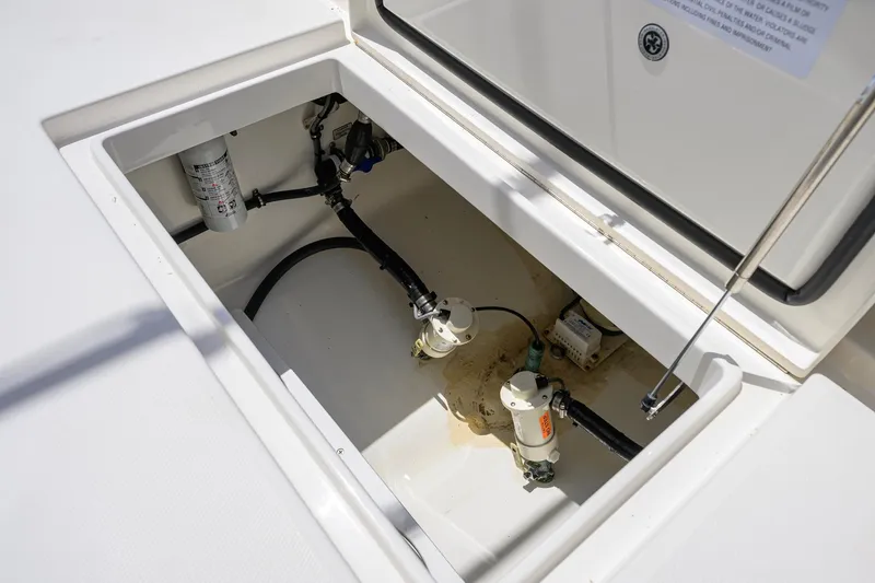 Slide: The Image of Open compartment of 2023 Regulator 28 boat showing internal components and wiring. - 53