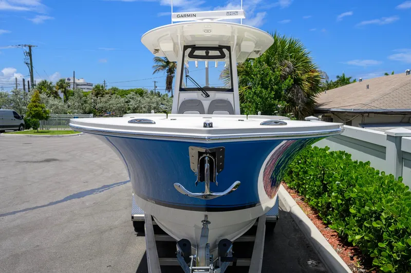 Slide: The Image of 2023 Regulator 28 boat with Garmin equipment, parked outdoors on a sunny day. - 6