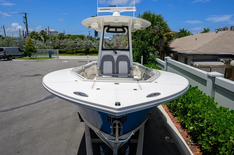 Slide: The Image of 2023 Regulator 28 boat with Garmin equipment, parked outdoors on a sunny day. - 7