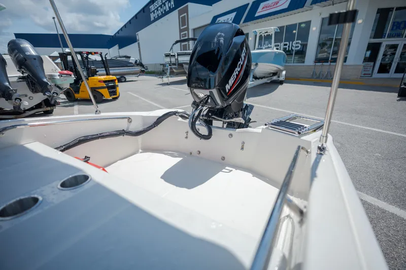 Slide: The Image of The image shows the stern of a Boston Whaler 130 Super Sport with a Mercury outboard motor. - 15