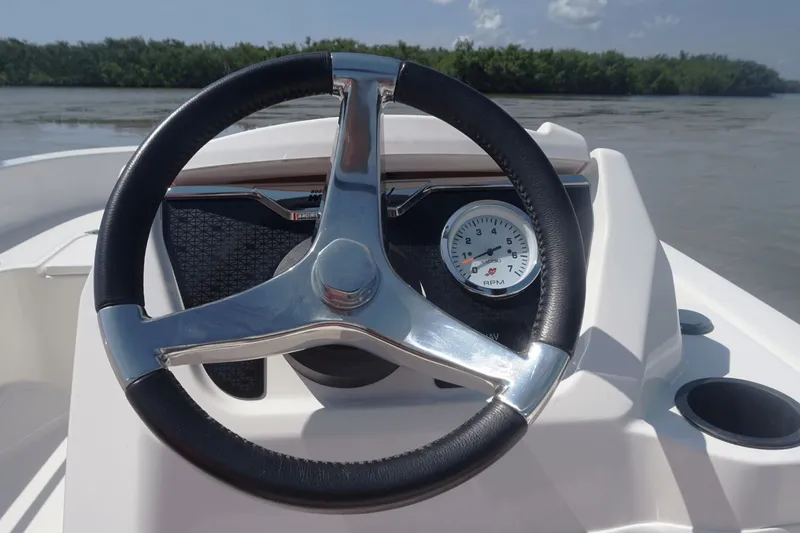 Slide: The Image of The image shows the steering wheel of a 2027 Boston Whaler 130 Super Sport. - 32