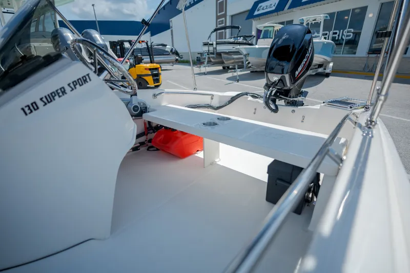 Slide: The Image of The image shows the cockpit of a 2027 Boston Whaler 130 Super Sport with an outboard motor. - 12