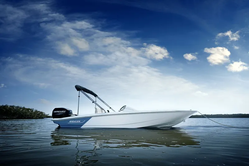 Slide: The Image of Boston Whaler 130 Super Sport 2027 on calm water under a blue sky. - 5