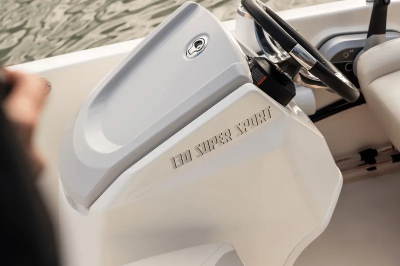 Slide: The Image of Close-up of the helm of a 2027 Boston Whaler 130 Super Sport. - 25