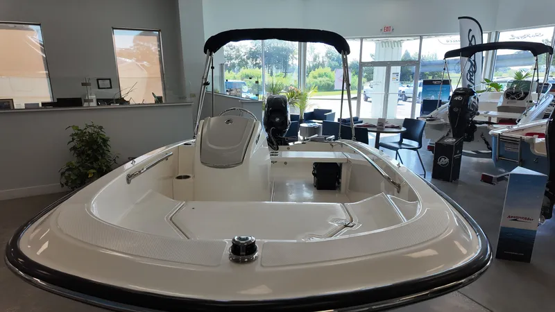 Slide: The Image of A modern 2027 Boston Whaler 130 Super Sport is displayed in a showroom. - 7
