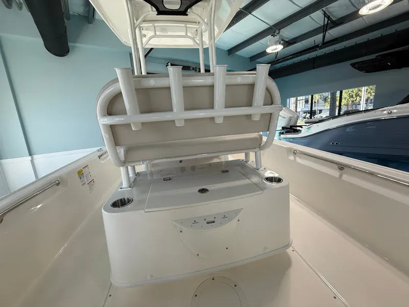 Slide: The Image of The image shows the cockpit of a 2027 Boston Whaler 210 Montauk with a bench seat and rod holders. - 16