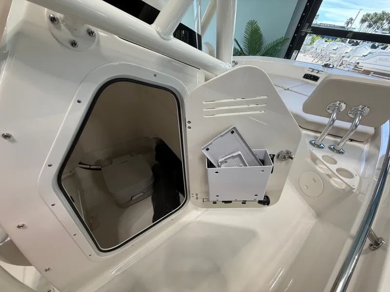 Slide: The Image of The image shows the interior of a 2027 Boston Whaler 210 Montauk with storage and helm console. - 18