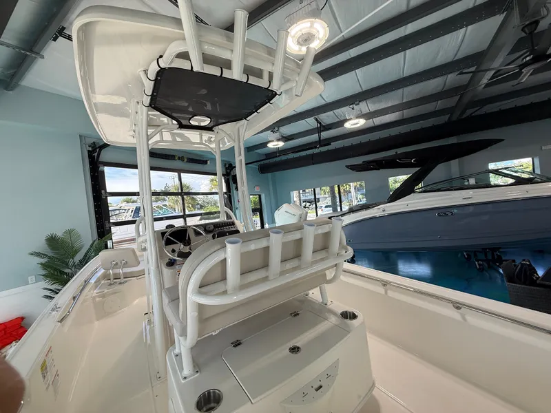 Slide: The Image of The image shows the cockpit of a 2027 Boston Whaler 210 Montauk in a showroom. - 15