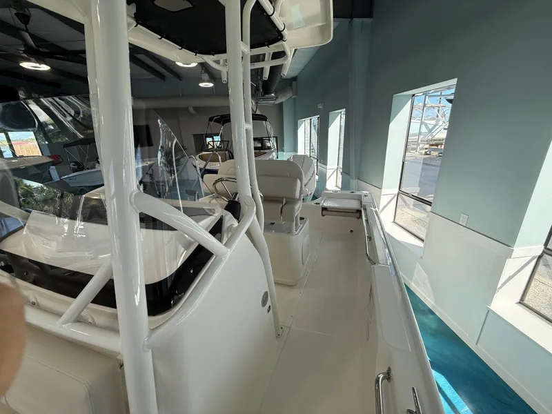 Slide: The Image of Interior view of a modern boat with white seating and clear windows in a showroom. - 11