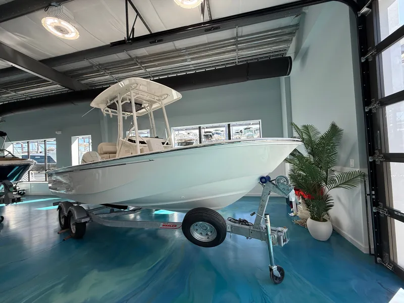 Slide: The Image of A 2027 Boston Whaler 210 Montauk on a trailer in a modern showroom. - 3