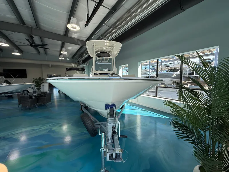 Slide: The Image of A 2027 Boston Whaler 210 Montauk is displayed on a trailer in a modern showroom. - 4