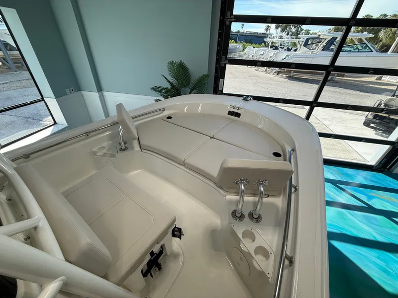 Slide: The Image of The image shows the interior of a 2027 Boston Whaler 210 Montauk with white upholstery. - 8