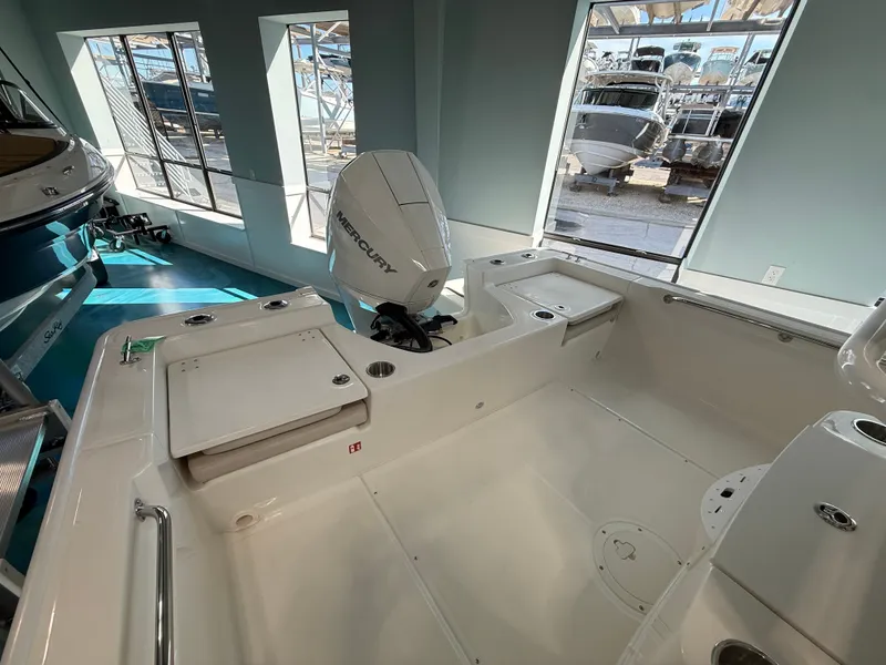 Slide: The Image of Interior view of a Boston Whaler 210 Montauk with a clean, spacious deck and Mercury engine. - 20