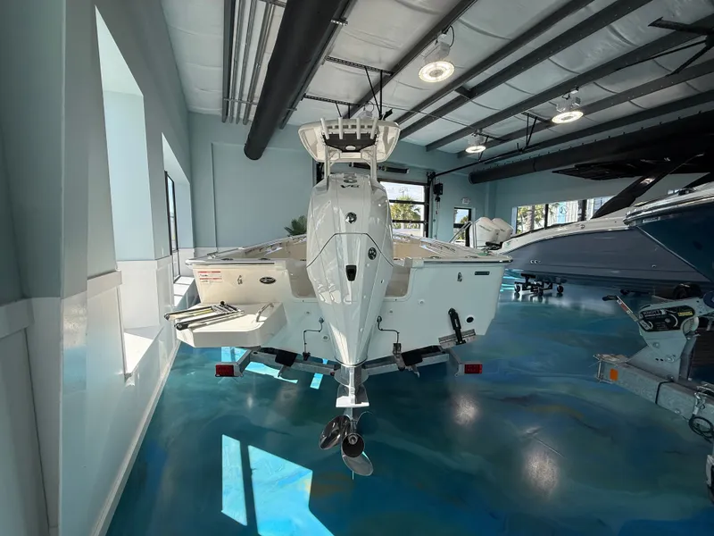 Slide: The Image of A 2027 Boston Whaler 210 Montauk is displayed in a modern showroom. - 6