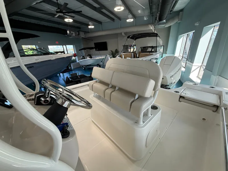 Slide: The Image of Interior of a Boston Whaler 210 Montauk with beige seating and steering wheel. - 12