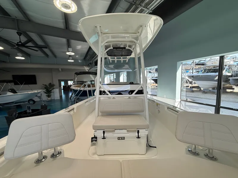 Slide: The Image of The image shows the deck of a 2027 Boston Whaler 210 Montauk in a showroom. - 9