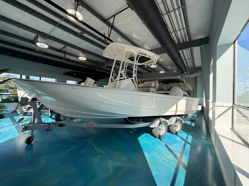 Slide: The Image of A 2027 Boston Whaler 210 Montauk on a trailer in a showroom. - 5