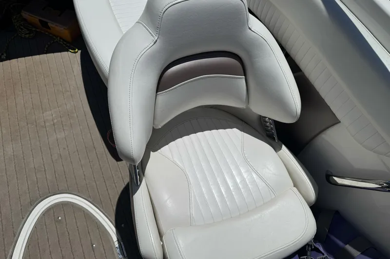 Slide: The Image of White leather seat on a 2009 Glastron GLS 215 boat interior. - 17