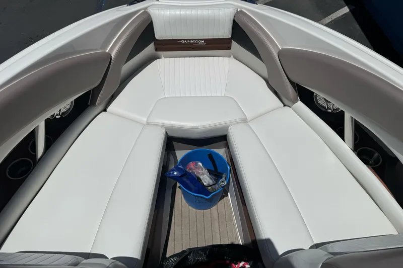Slide: The Image of 2009 Glastron GLS 215 boat interior with white seating and a blue bucket. - 18