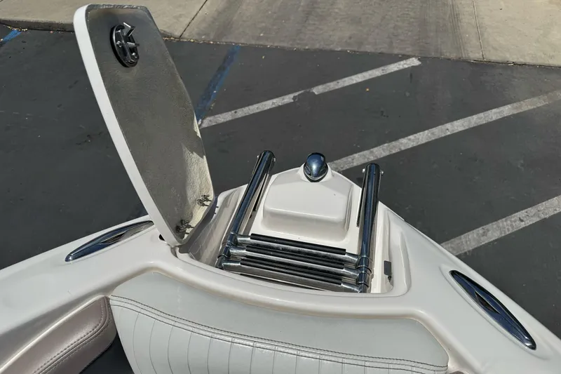 Slide: The Image of 2009 Glastron GLS 215 boat ladder compartment with open hatch, showing stainless steel ladder. - 19