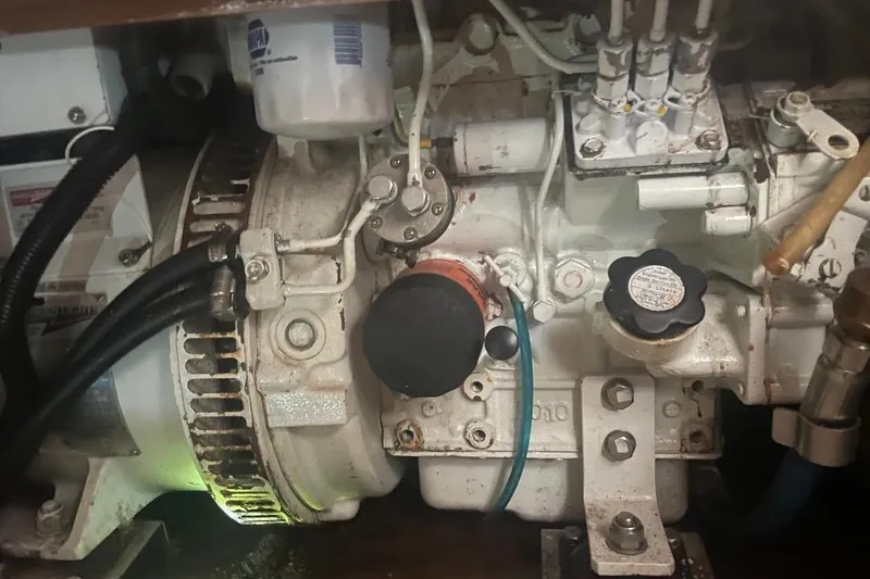 Slide: The Image of Engine compartment of a 1994 Island Packet 44 cutter sailboat, showing mechanical components. - 117