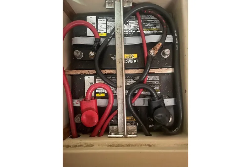 Slide: The Image of Battery compartment of a 1994 Island Packet 44 cutter with visible cables and connections. - 119