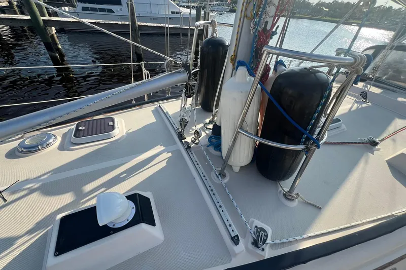 Slide: The Image of Deck view of 1994 Island Packet 44 cutter sailboat with rigging and fenders. - 12