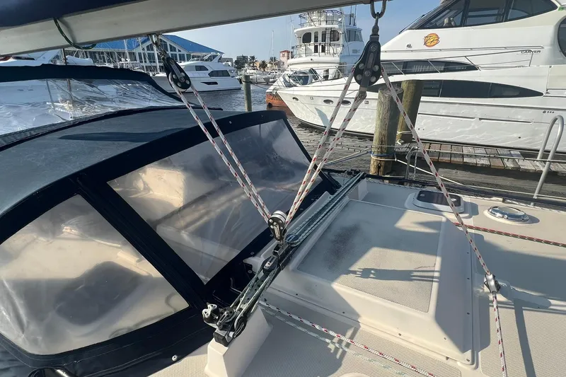 Slide: The Image of 1994 Island Packet 44 cutter sailboat deck with rigging and marina view. - 13