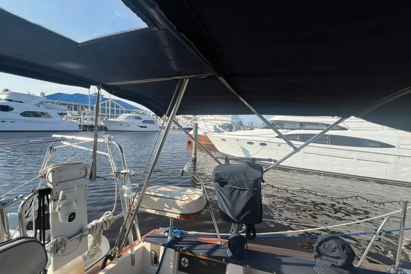 Slide: The Image of 1994 Island Packet 44 cutter sailboat docked at marina with other yachts. - 14