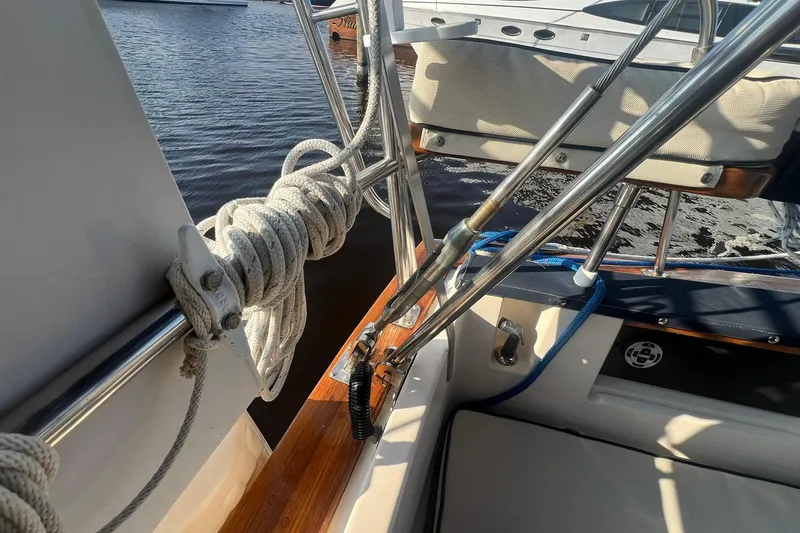 Slide: The Image of 1994 Island Packet 44 cutter sailboat deck with ropes and stainless steel fittings. - 22