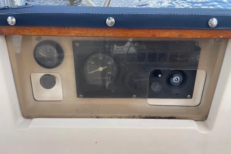 Slide: The Image of Control panel of a 1994 Island Packet 44 cutter sailboat, featuring gauges and switches. - 26