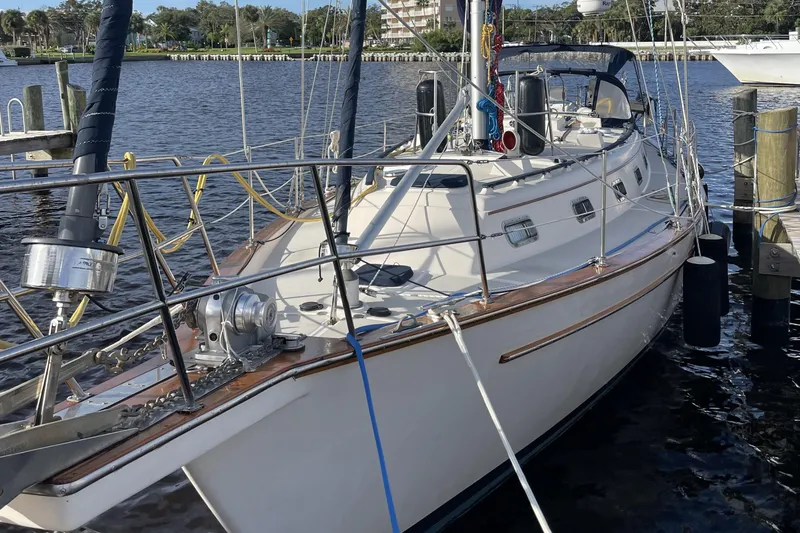Slide: The Image of 1994 Island Packet 44 cutter sailboat docked by the waterfront. - 4