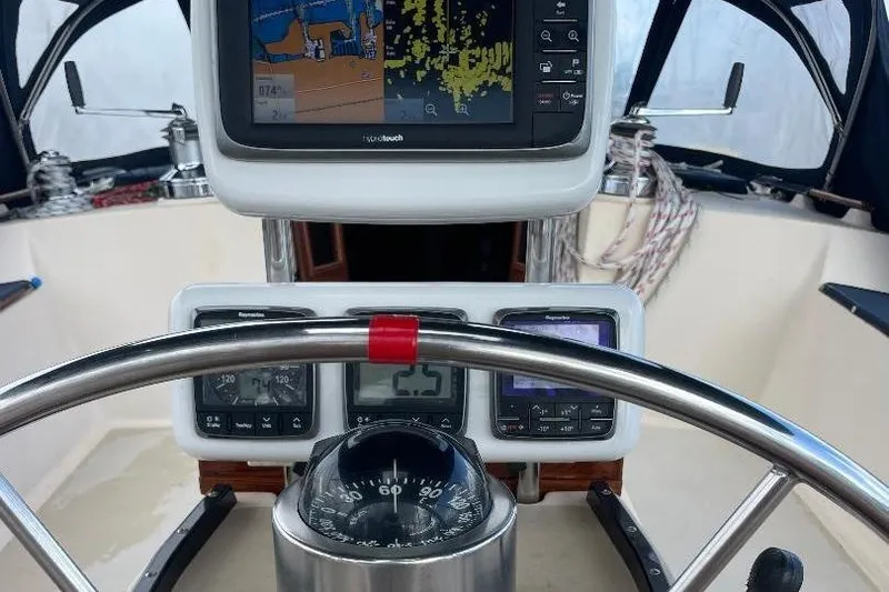 Slide: The Image of Cockpit of 1994 Island Packet 44 cutter with navigation instruments and steering wheel. - 49