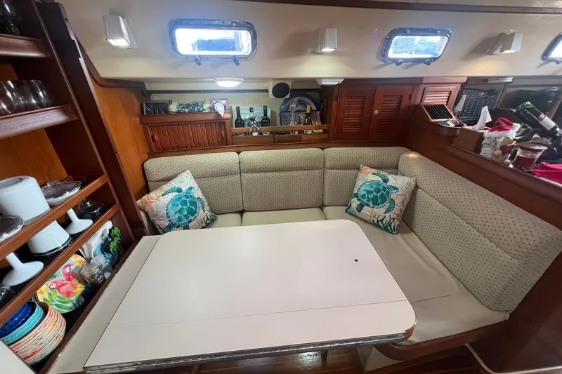 Slide: The Image of Cozy dining area in 1994 Island Packet 44 cutter sailboat with turtle-themed decor. - 64