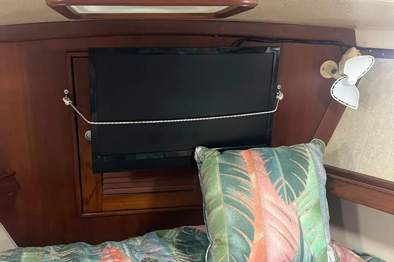 Slide: The Image of Interior of 1994 Island Packet 44 cutter with TV, fan, and tropical pillow. - 91
