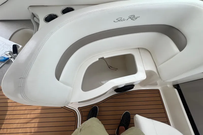 Slide: The Image of 2003 Sea Ray 320 Sundancer boat interior with white seating and wood flooring. - 30