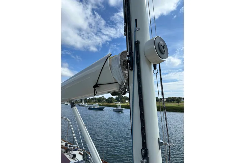 Slide: The Image of 1979 Nielsen 44 Cutter Rigged sailboat mast and rigging on a calm waterway. - 12