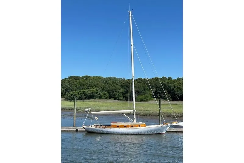 Slide: The Image of 1979 O.Lie-Neilsen 44 Cutter Rigged sailboat docked under blue sky. - 14