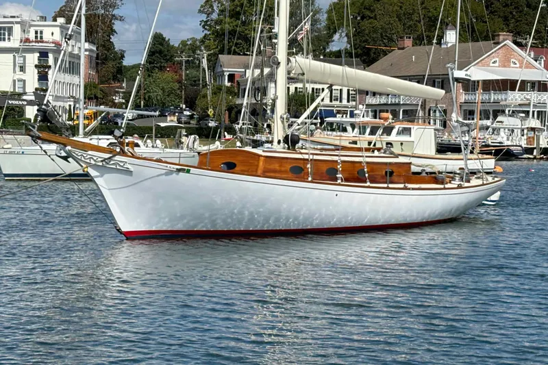 Slide: The Image of 1979 O.Lie-Neilsen 44 Cutter Rigged sailboat docked under blue sky. - 3
