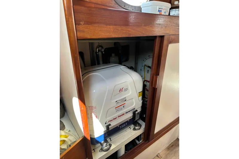 Slide: The Image of Generator inside a 1979 Nielsen 44 Cutter Rigged sailboat's wooden cabinet. - 33