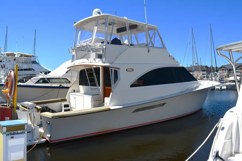 The Image of 2001 Ocean 56 Super Sport yacht docked in a marina under clear blue skies. - 0