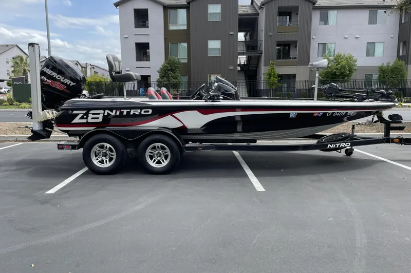 Slide: The Image of 2013 Nitro Z-8 boat with Mercury engine on trailer in parking lot. - 1