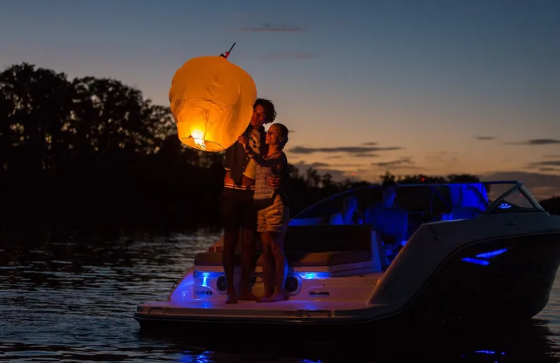 Slide: The Image of People on Sea Ray SLX 250 boat releasing lantern. - 21
