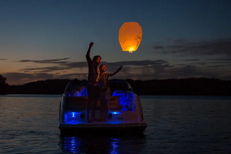 Slide: The Image of Couple on Sea Ray SLX 250 at night with lantern. - 22