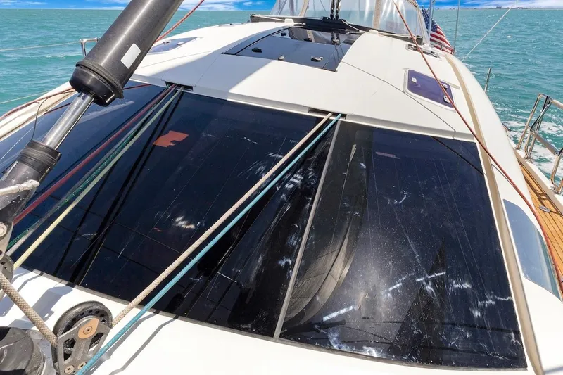 Slide: The Image of 2011 Southerly 57 RS yacht deck with ropes and windows, sailing on turquoise water. - 14
