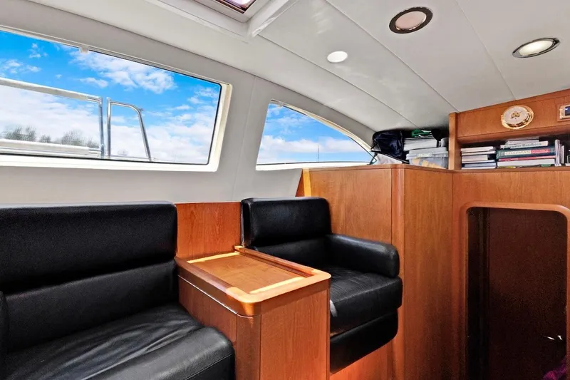 Slide: The Image of Interior of 2011 Southerly 57 RS yacht with black seating and wooden accents. - 30