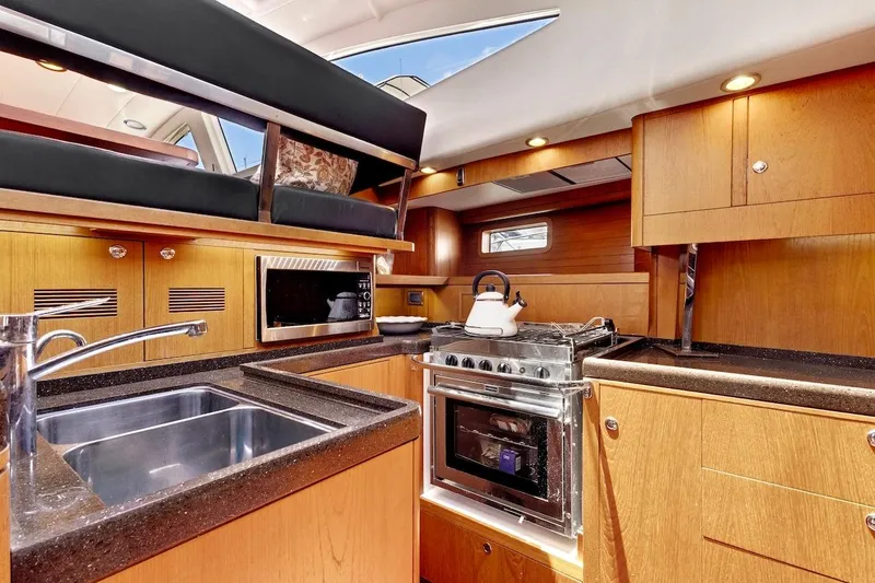Slide: The Image of Luxurious 2011 Southerly 57 RS yacht kitchen with modern appliances and sleek wood cabinetry. - 34