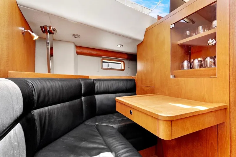 Slide: The Image of Interior of 2011 Southerly 57 RS yacht with wooden cabinetry and black leather seating. - 38