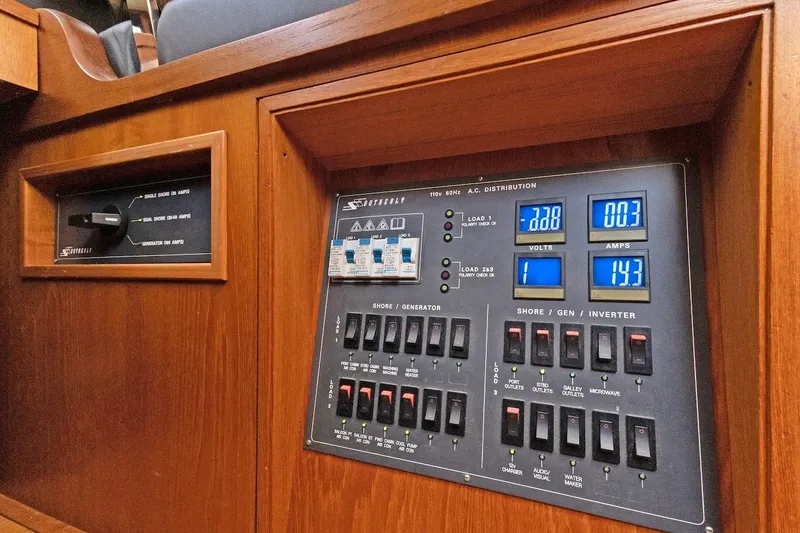 Slide: The Image of Electrical control panel on a 2011 Southerly 57 RS yacht, featuring voltage and amperage displays. - 44