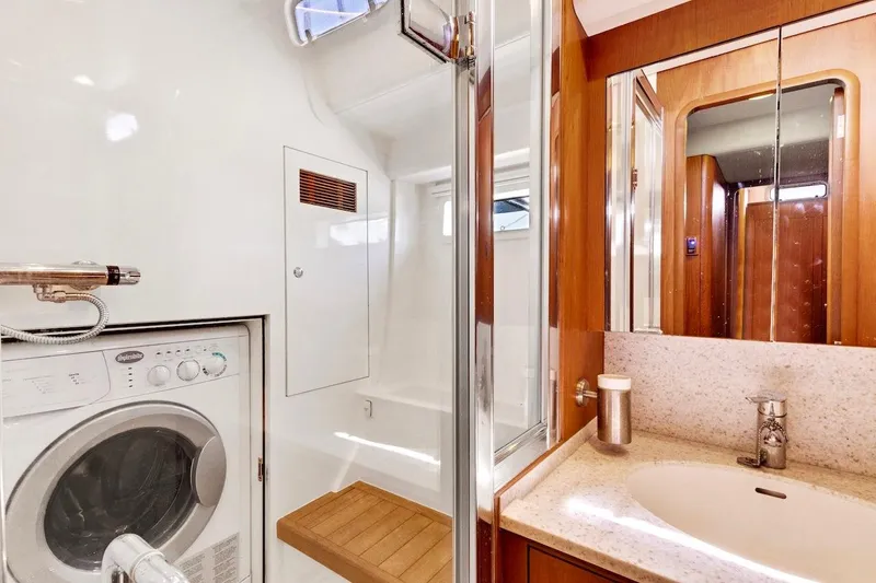 Slide: The Image of Laundry and bathroom area in 2011 Southerly 57 RS yacht, featuring washer and modern fixtures. - 56